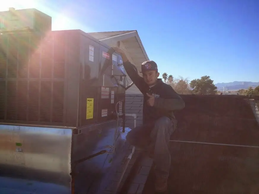 HVAC technician performing Boiler Repair on a rooftop unit in Fircrest